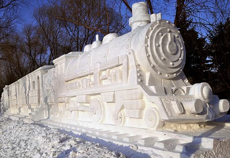 Harbin 2009 Ice &amp; Snow Festival: Snow Train with a Steam Engine on each side. The wagons are partly carved out for visitors to go inside.  This photo was taken by flickr user frankartculinary.