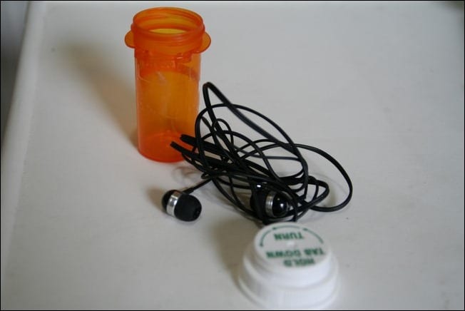 Ear bud headphones fit right in pill bottles.  This will keep them from getting tangled and/or lost in your backpack, purse, etc.