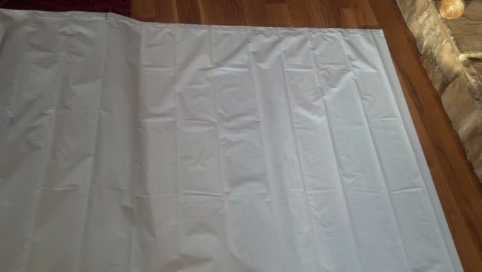 Measure and cut a shower curtain to fit the mast of the raft.
