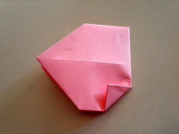 Let's continue making the origami heart. Make a small triangle on the lower right corner.