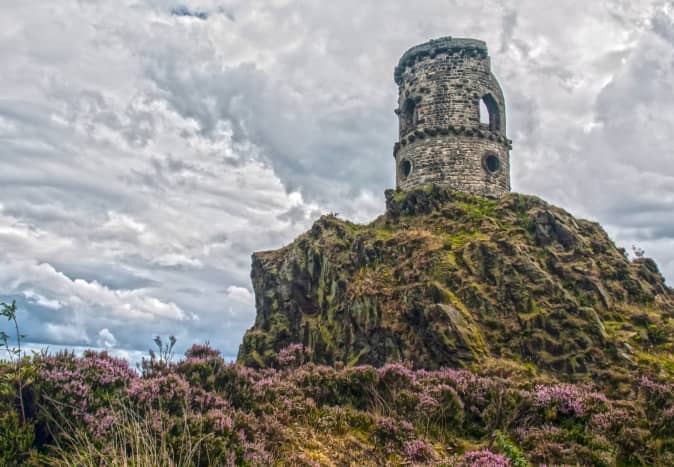 Perched on the summit of a rocky gritstone outcrop The tower or Mow Cop castle is a striking landmark that can be seen from miles around.