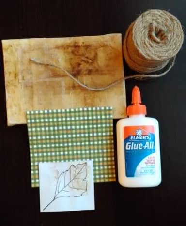 Materials needed for creating the teabag-wrapped canvas and pasting a tea stain drawing onto it.