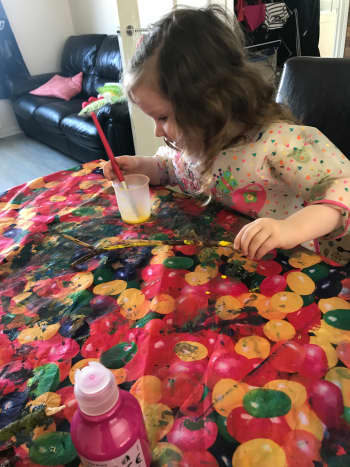 My granddaughter painting twigs for her Easter tree