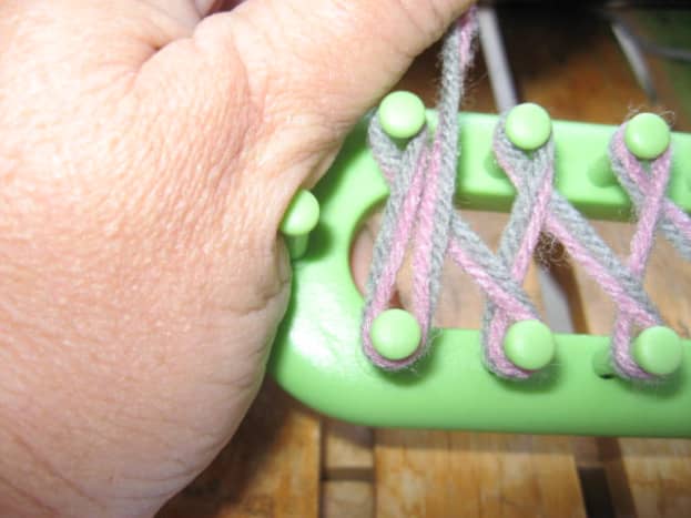 When you get to the end, turn loom around, and wrap pegs as shown. Then pull yarn straight across and hold for a moment.