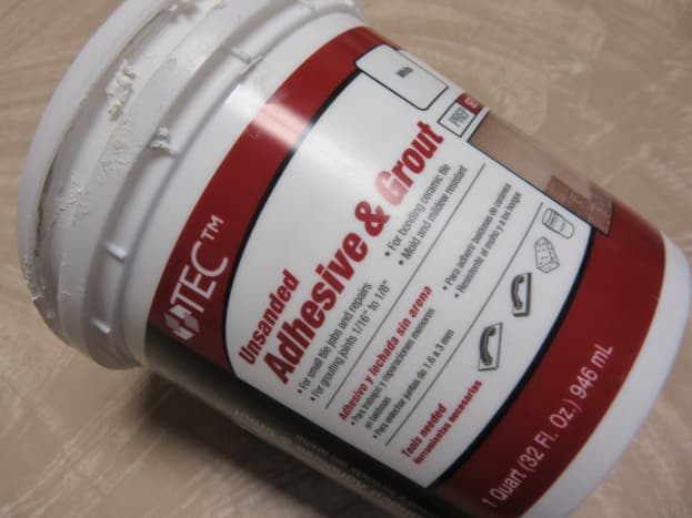 We like to use an adhesive and grout mixture that can be purchased ready to use.