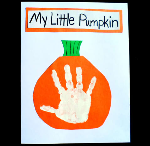 Add a white handprint in the middle of an orange pumpkin.