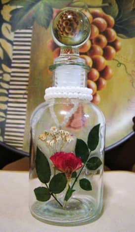 A bottle decorated with pressed roses