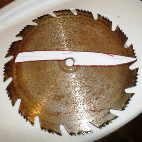 Old saw blade with the knife cut out.