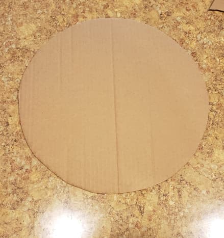 Cut a large circle out of cardboard.