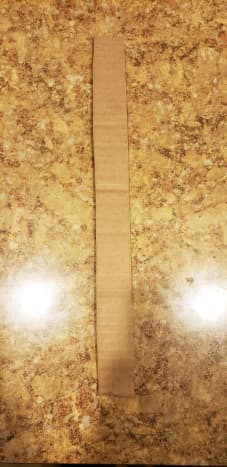 Cut a long, rectangular strip from cardboard.