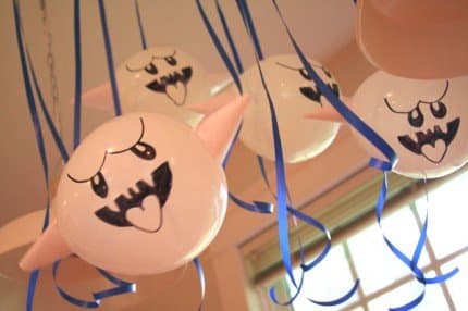 A gaggle of Boo balloons with paper cone arms.