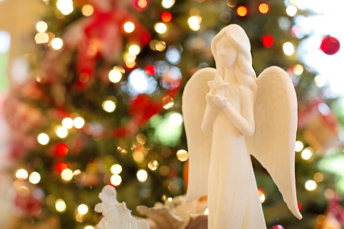 An angel is often placed at the top of a Christmas tree.