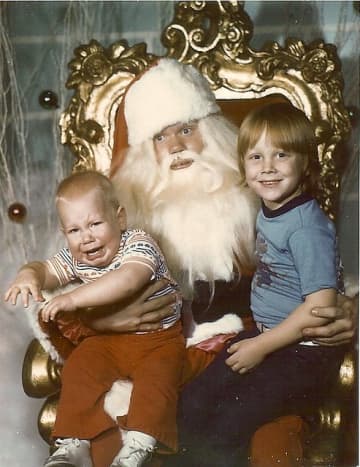 What a priceless expression on Santa's face!  And look at the older brother who is enjoying the whole experience!