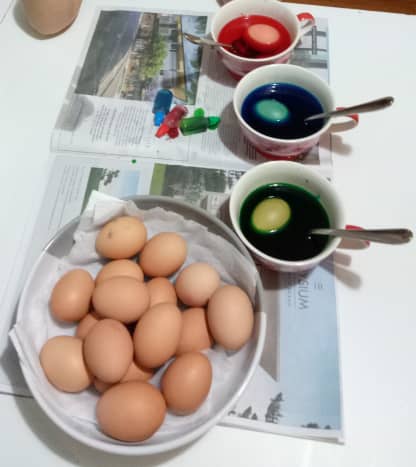 While the eggs are submerged in the dye mixes, dunk them up and down using spoons. 