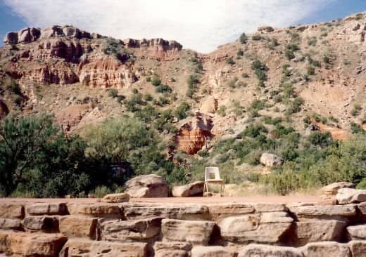 Ground level view of stage with dramatic backdrop at Pioneer Ampitheater in Palo Duro Canyon