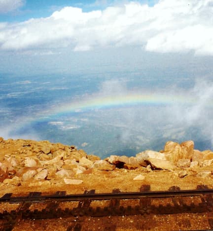 View of the cog railway track and beautiful rainbow at the top of Pikes Peak.