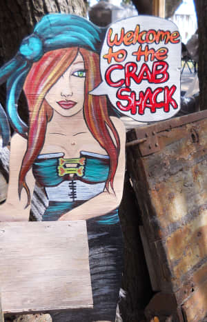 Cartoon waitress greets you at the entrance to the Crab Shack dining area.