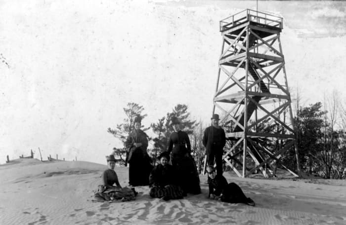People on top of Mount Baldhead in front of tower being constructed. Where are the trees?