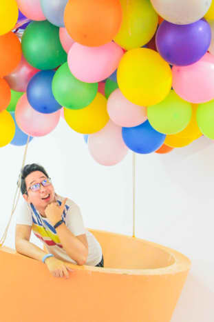 The author flying with the help of some balloons