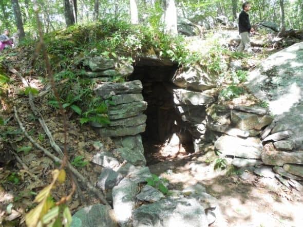 This rock structure is under a mound of dirt. If you look to the right of the entrance you can see another little side chamber.