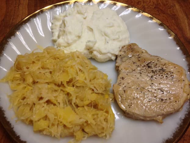 Meal with pork chop. Selenium can be found in lean meats, such as pork. 