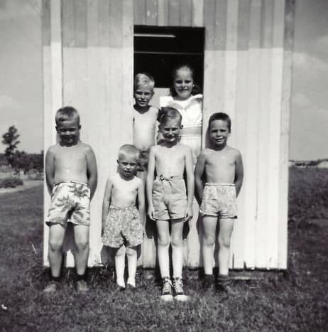My cousins, brothers and me in the playhouse my dad built for us.  This was prior to it being finished with actual windows and a door.  