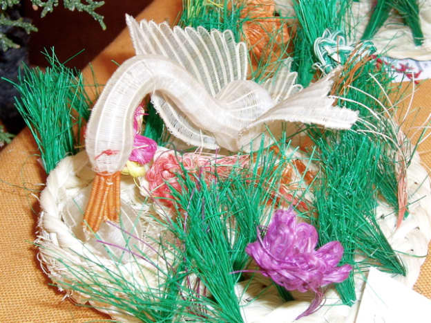 Chile used the most unique materials. This swan is made from dyed horsehair. It comes from a cooperative in Rari, Chile, which is renowned for its miniature horsehair weavings.