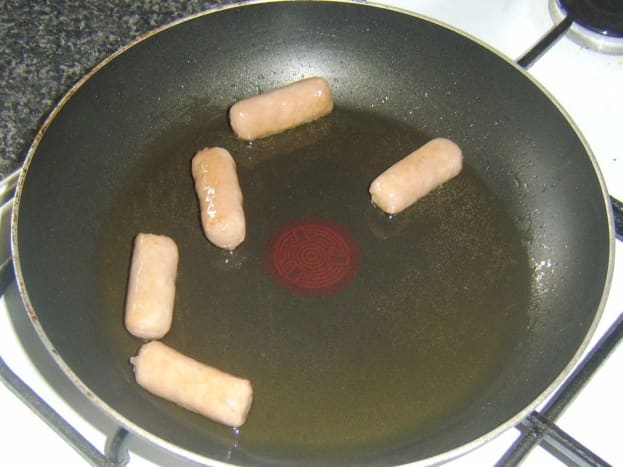 Gently frying mini sausages
