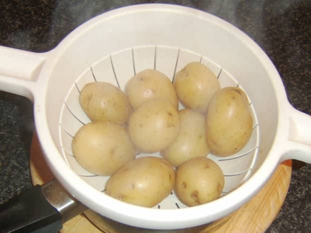Boiled potatoes are drained and allowed to steam for five minutes