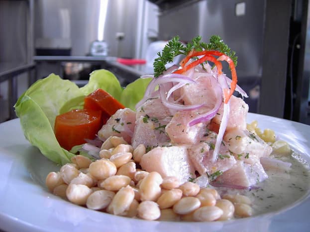 Halibut ceviche piled high and served with beans.