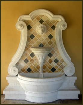 carved stone and yellow and brown tiles set the stage for this water fountain