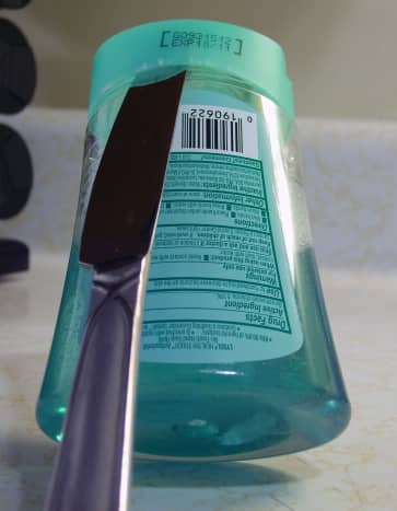 After fully inserting a flat tool as pictured here, move it to either side of the container. Pulling up on the tool will cause the Lysol Healthy Touch refill lid to pop off.