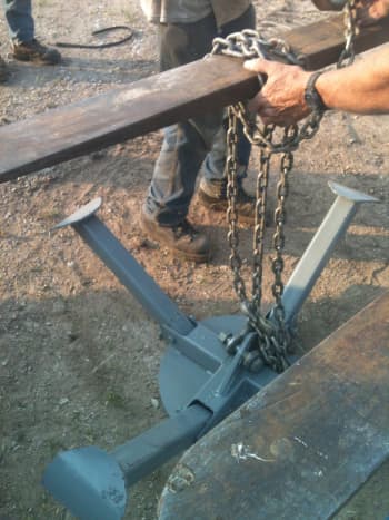 The lifting ring is chained to the boom of your crane or other lifting vehicle. Experiment with your chaining method so you can work out whatever results in the most balanced, secure combination of hooks, bolts, and chain wraps.