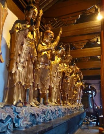 There were 16 &quot;saints&quot; when Buddhism came to China from India, but over time China added two more of their own, and now there are 18 Luohan - Saints.  They are shown surrounding the Buddhas in the main hall of the temple, and like the saints of Chris