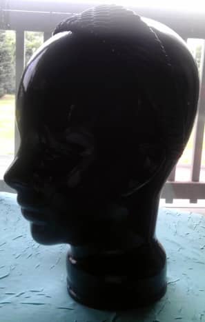 Ceramic head modeling a puffed pleather headband.