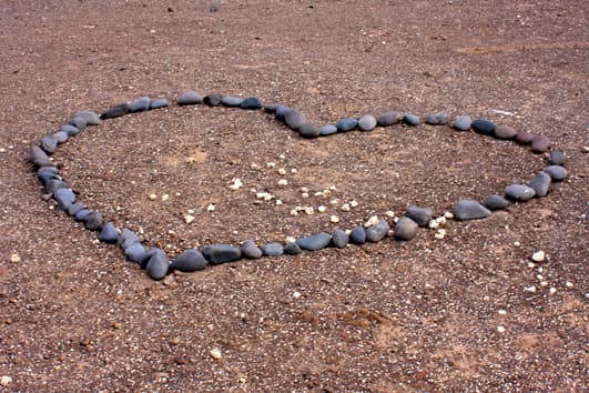 Lovers have a habit on the headlands of creating hearts out of stones