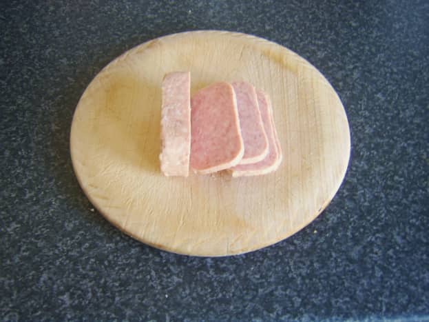 Moderately thin slices of Spam taken from block