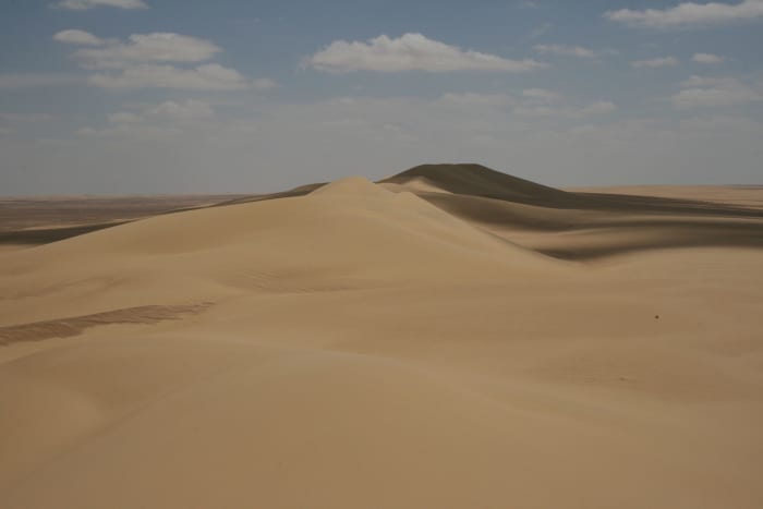 The Qattara Depression is the largest in the world. It lies 436 feet below sea level, and its bottom is covered with salt pans, sand dunes, and salt marshes.