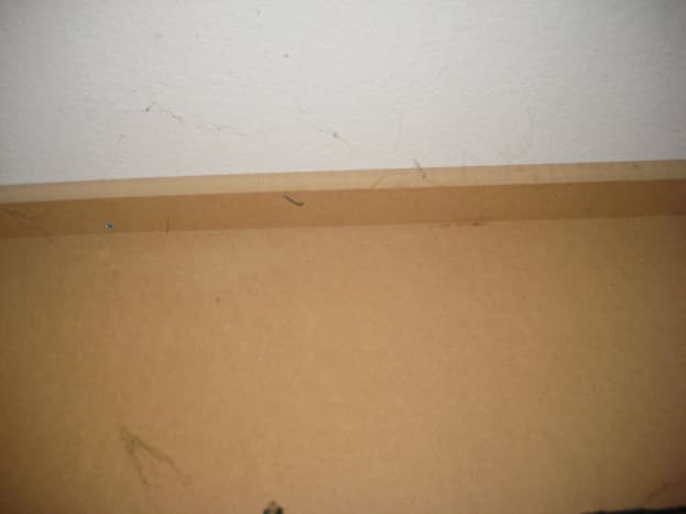 Batten securing board to ceiling