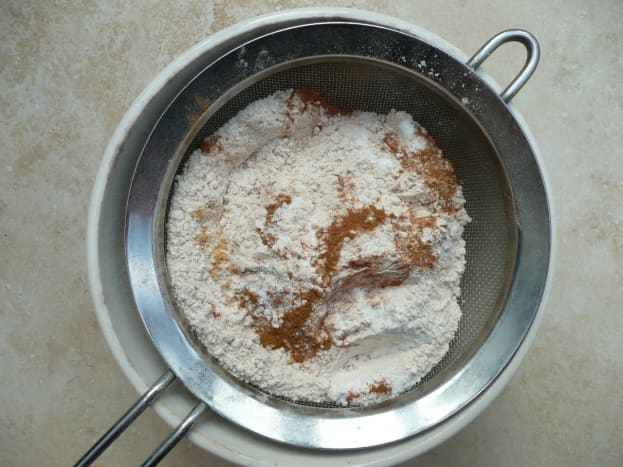 Sifting flour, baking powder, baking soda and spices.