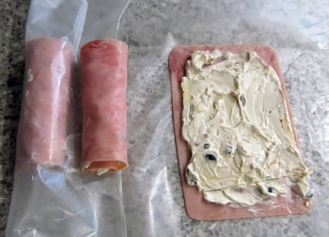 Spread cream cheese on boiled ham slices