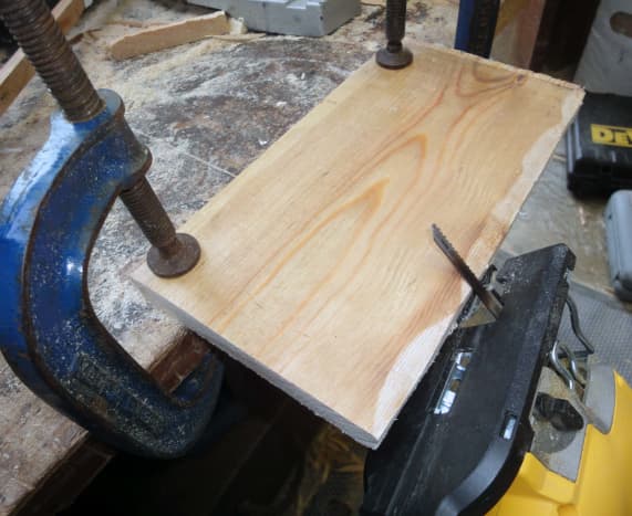 hewing pine floorboards to make shelving