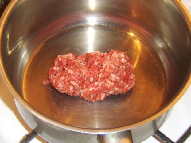 Ground/minced beef is added to dry pot