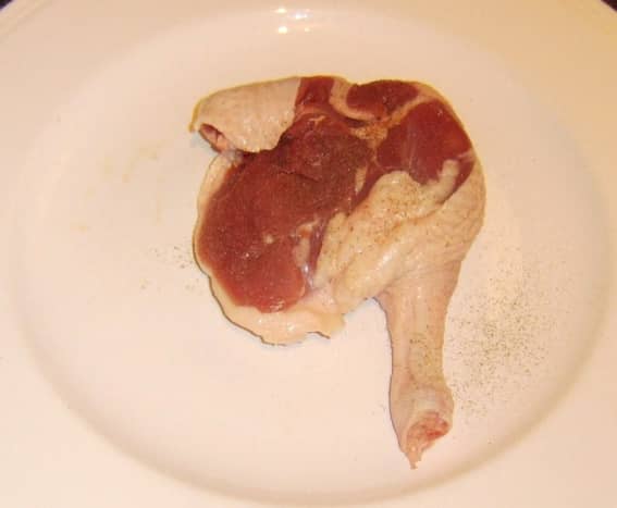 Duck leg is seasoned before it is roasted