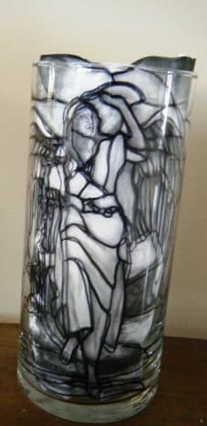 This is a stained glass themed candle holder with the stained glass picture scotch taped to the inside.