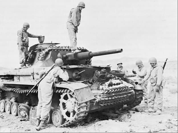 American troops inspect a captured German tank.