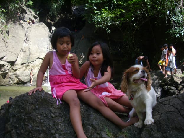 My nieces with Angus sitting on a huge rock  at Busay Waterfalls.