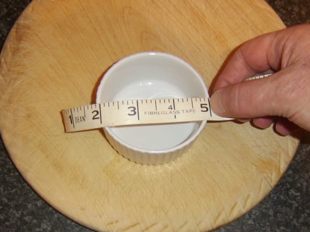 Measuring ramekins before cutting puff pastry casings