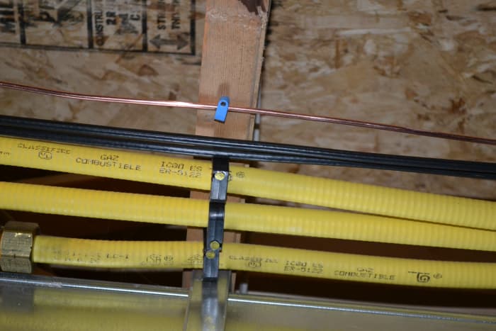 An example of the CSST gas line being properly secured to an overhead beam on our basement ceiling