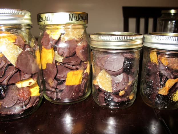 Chocolate covered dried fruits in a jar